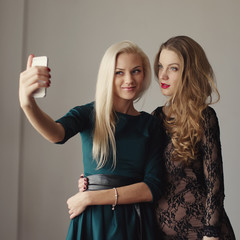 beautiful girls making selfie on mobile phone