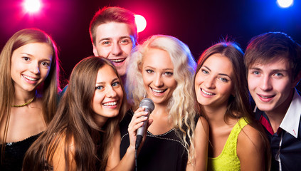 Young people singing at party