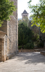 Fototapeta na wymiar Pollensa street with church tower. Mallorca, Spain.