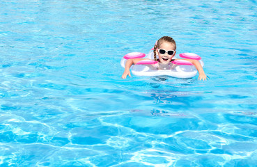 Smiling little girl in swimming pool