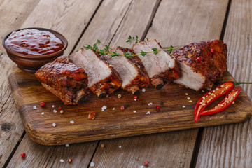baked pork ribs on a wooden board