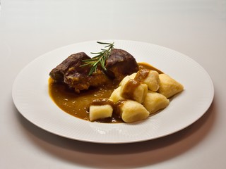 Roasted wild game in ginger bread sauce with potato dumplings