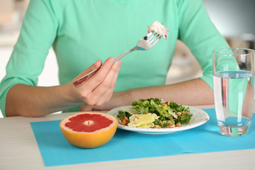 Girl and dietary food at table close-up