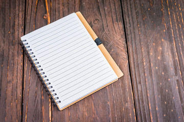 Note book on wooden background