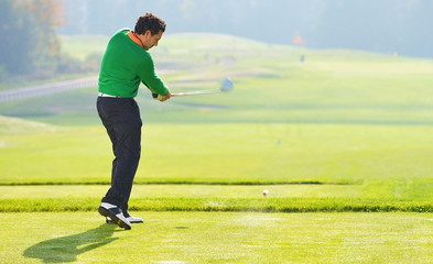 Golfer swing, teeing off on beautiful summer morning