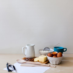 recipe and baking ingredients with glasses