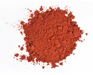 Heap of ground paprika on a white