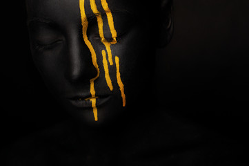 lady in black paint with yellow smudges