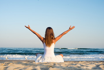 Woman meditating at the sea