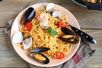 Tasty pasta with mussels and squid on the plate