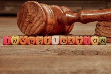 Sign INVESTIGATION and Wooden Gavel