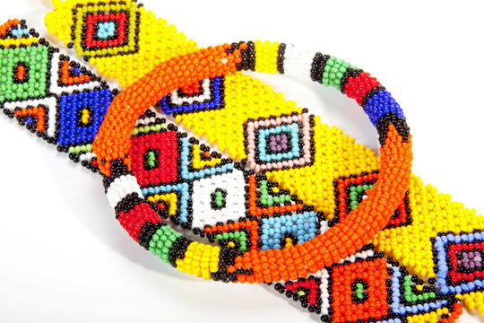 Circular Beaded Zulu Armband Atop Two Wristbands