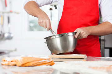 Chef Mixing Batter To Prepare Ravioli Pasta In Kitchen