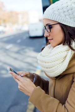 Young beautiful woman using her mobile phone on a  bus.