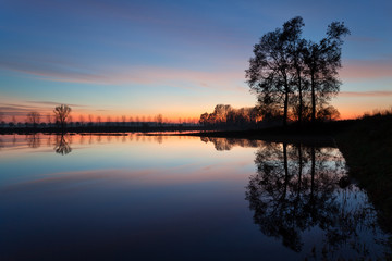Fototapeta na wymiar Flooded countryside at sunset