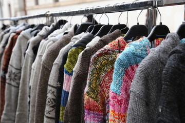 wool sweaters and vintage clothes for sale in open-air flea mark