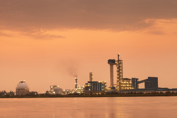Fototapeta na wymiar Sunset time of Oil refinery with reflection, petrochemical plant