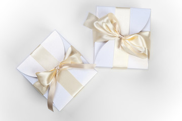 White boxes with gold bow
