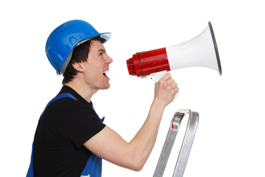 Young worker man with blue helmet shouting in loudspeaker isolat