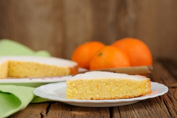 Cut clementine pie with clementines on wooden background