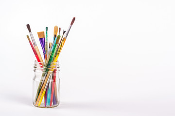 isolated paints brushes in a glass
