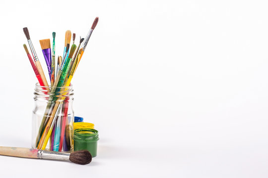 isolated paints brushes in a glass