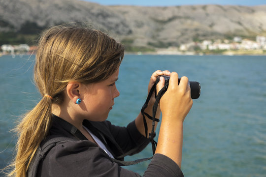 Girl Is Taking A Photo With Camera At Sea