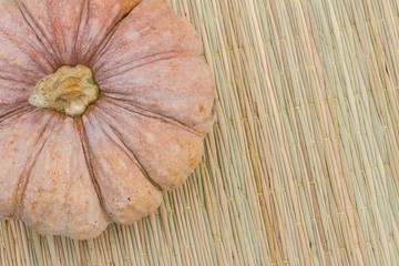 Still Life pumpkin on traditional mat with copyspace