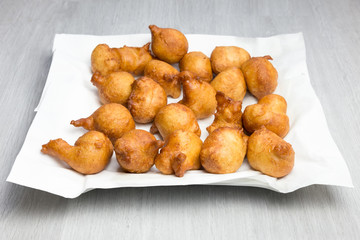 apple fritters on paper napkins in scale