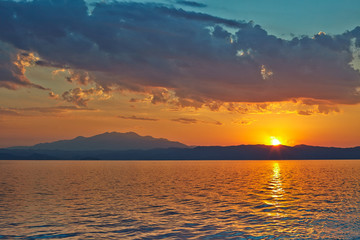 Sunset over the Greece, waves from the ferry, and the