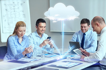 smiling business people with gadgets in office