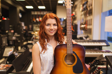 assistant or customer with guitar at music store