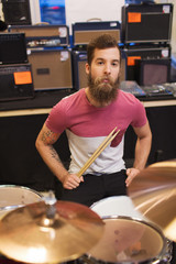 Obraz premium male musician playing cymbals at music store