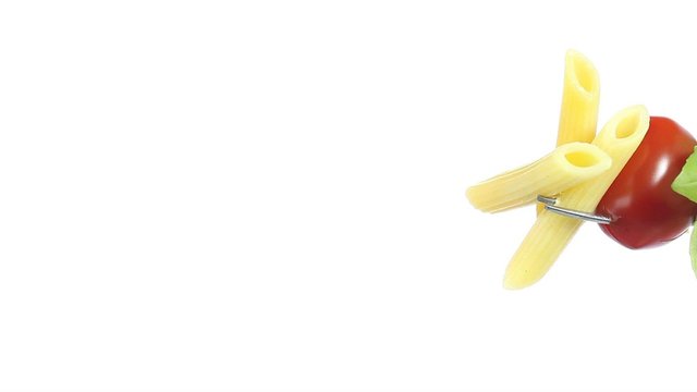 fork pasta with tomato cherry and basil topped with spilled oil 