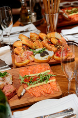 Italian appetizers on wooden plank