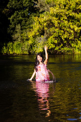 Japanese American Woman In River Splashing Water