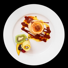 Ice-cream dessert with fruits in plate, isolated