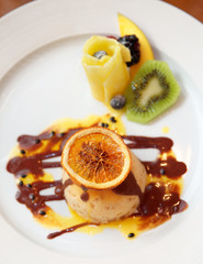 Ice-cream dessert with fruits in plate