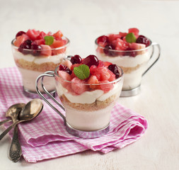 No-bake cheesecake with apple and cranberry compote in glass cup