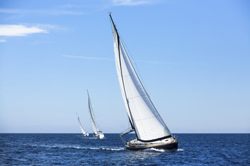 Sailing ship yachts with white sails. Luxury yachts.
