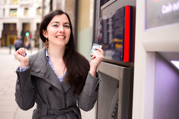 young woman celebrating at the cash machine