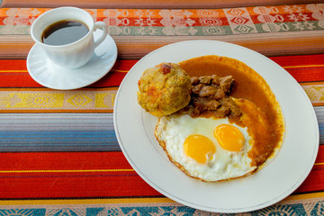Bolon de verde with fried egg and meat stew ecuadorian food