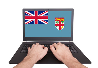 Hands working on laptop, Fiji