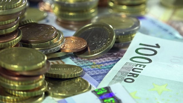 Money (Euro coins and banknotes) as 4K dolly shot
