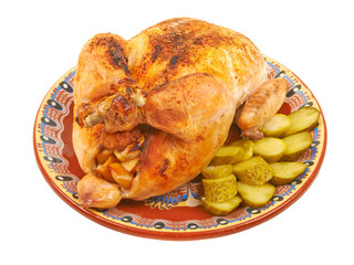 Fried chicken on a plate with pickles on a white background isol