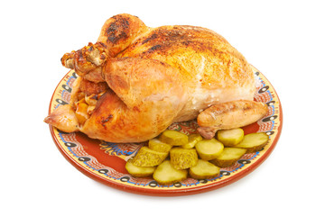 Fried chicken on a plate with pickles on a white background isol