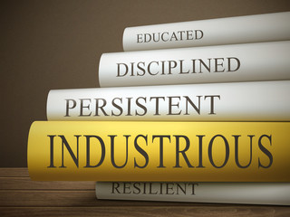 book title of industrious isolated on a wooden table