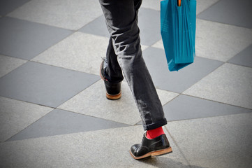 Man with red socks and plastic bag