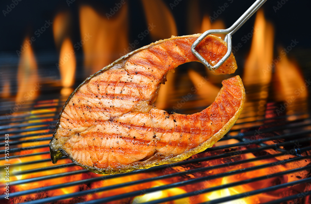 Poster grilled salmon on the flaming grill