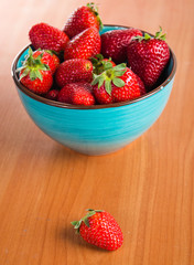 Strawberries in a Bowl, ona a wooden background